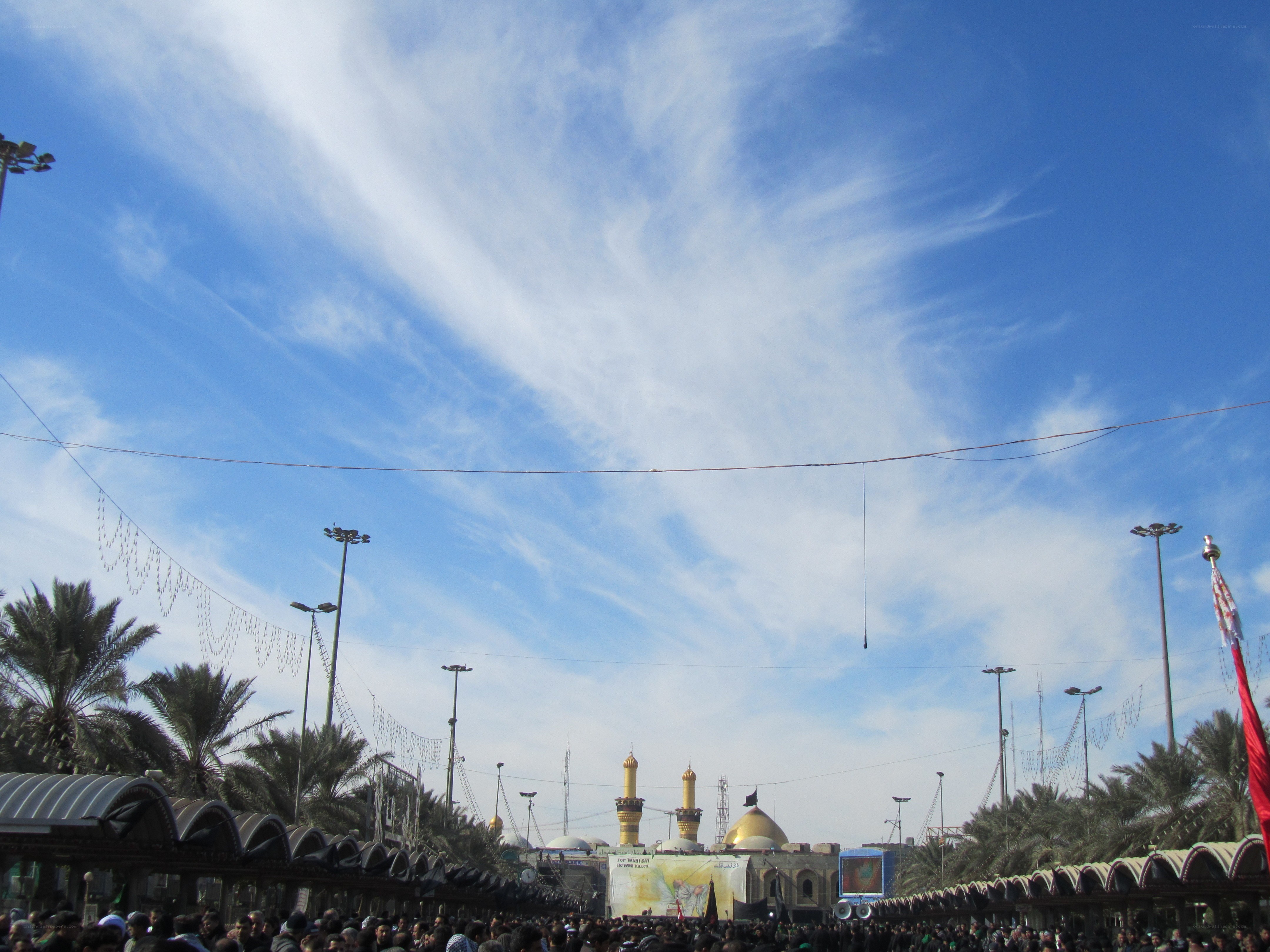Crowded religious gathering under blue sky