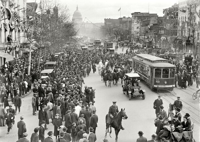 Crowded street with Capitol in background