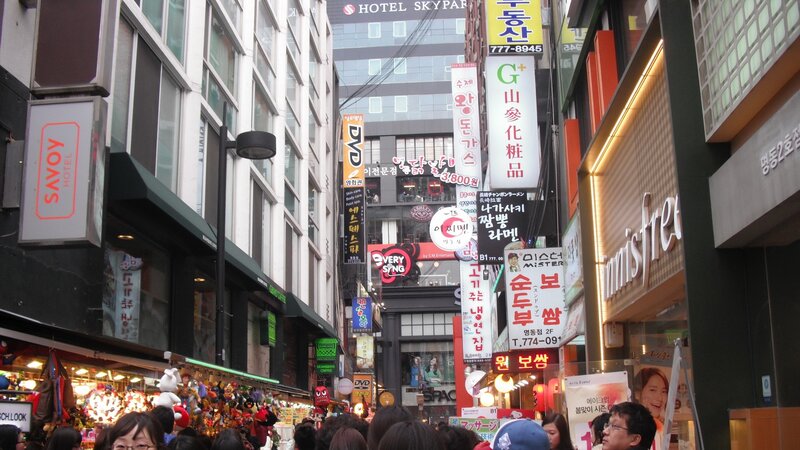 Crowded Street with Signs — White