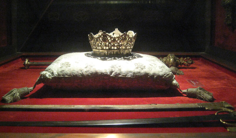 Crown on a pillow with swords