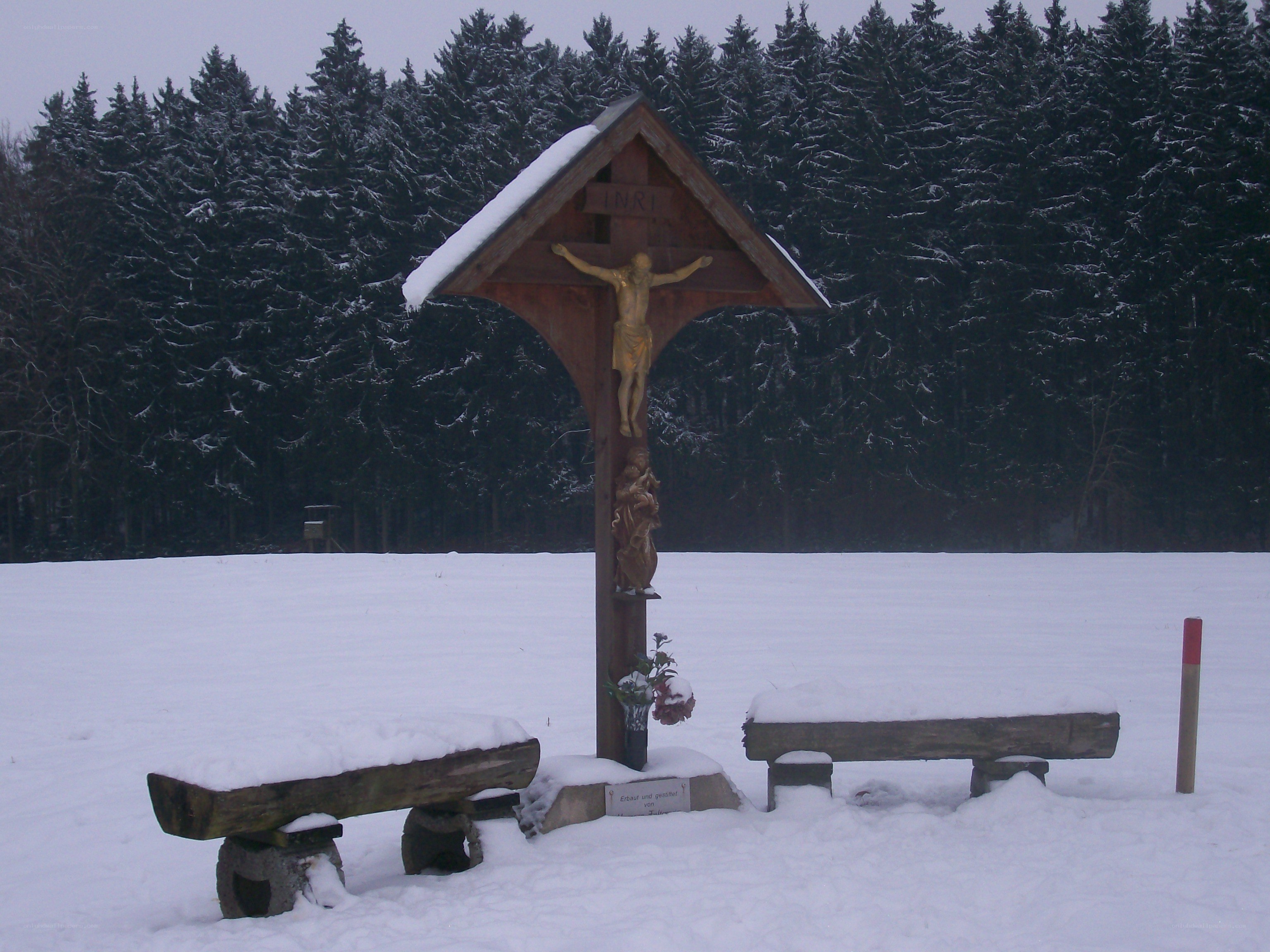 Crucifix in snowy field