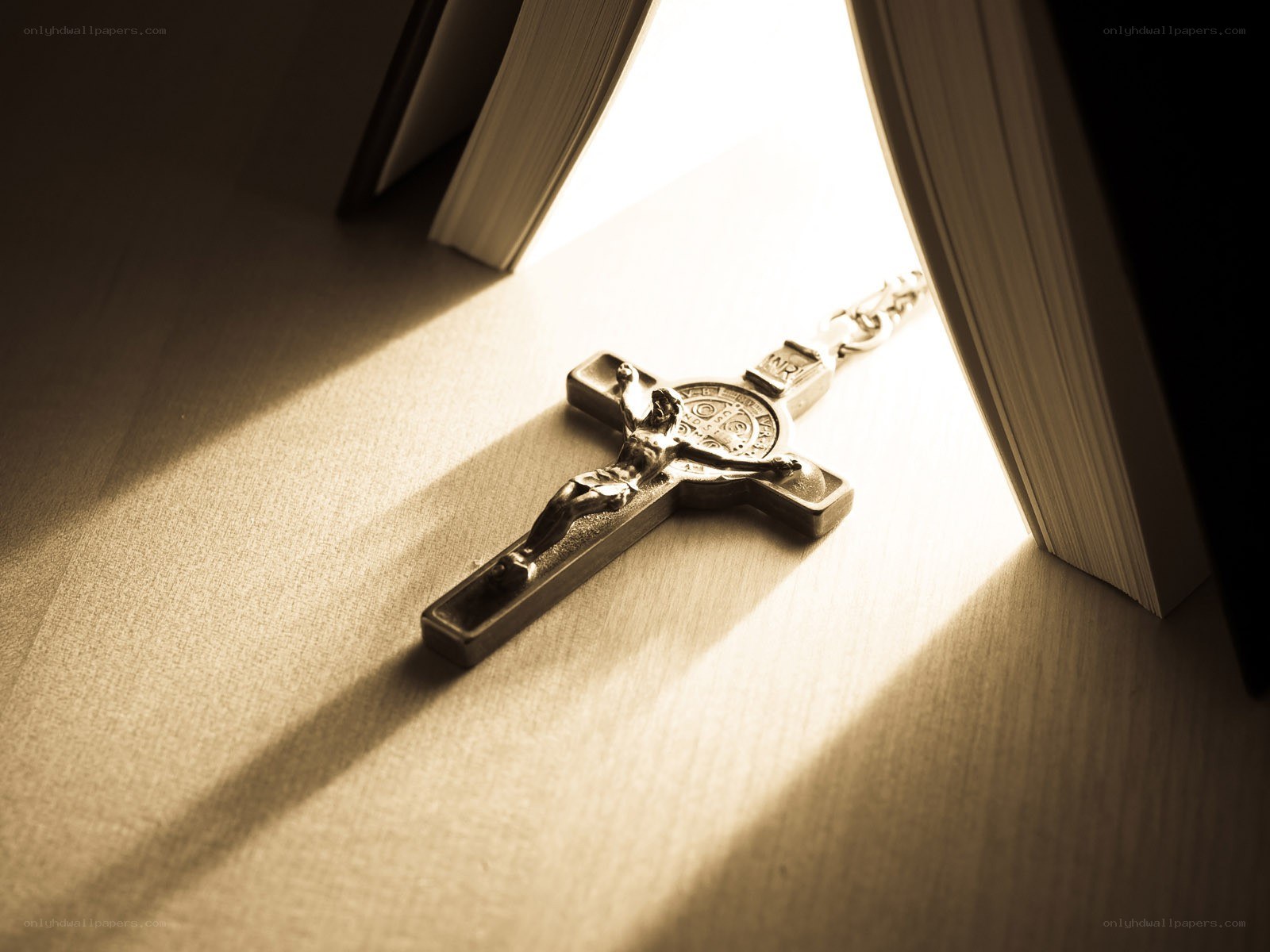 Crucifix in sunlight between books