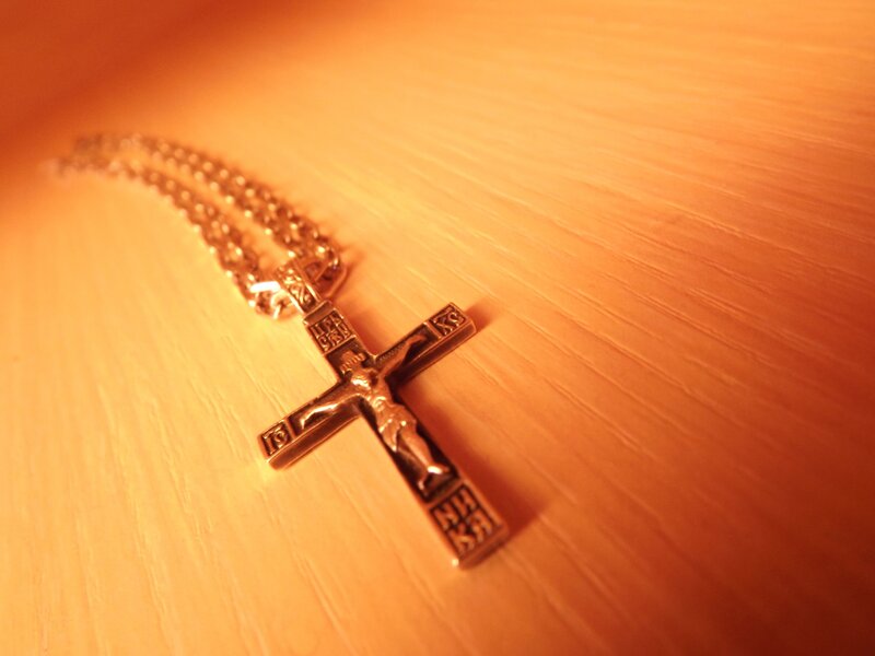 Crucifix pendant on wood