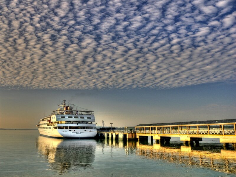 Cruise ship at dock under cloudy sky