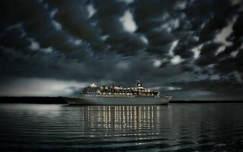 Cruise ship at night under stormy sky