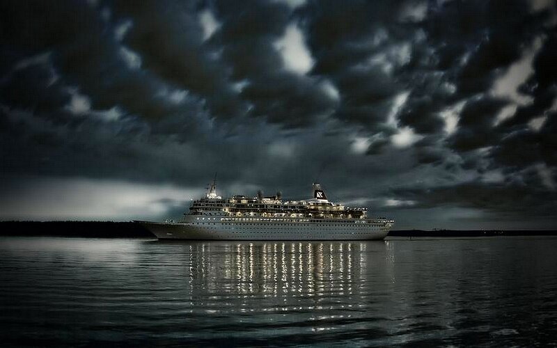 Cruise ship at night under stormy sky