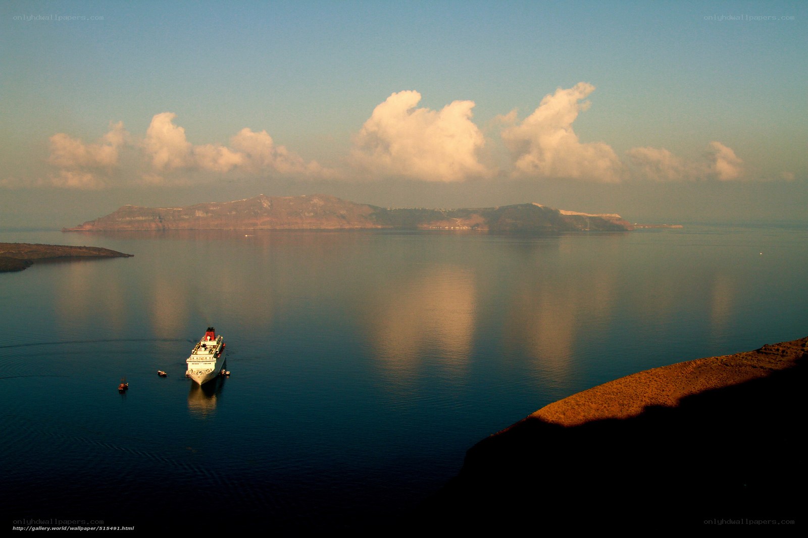 Cruise ship in caldera at sunset