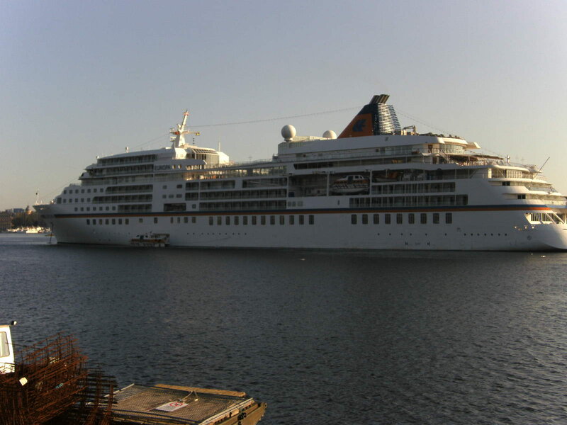 Cruise Ship in Harbor — White, Calm, Afternoon, Photograph, Small Boat