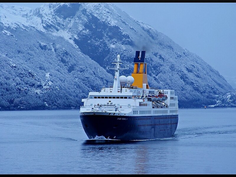Cruise ship in snowy fjord