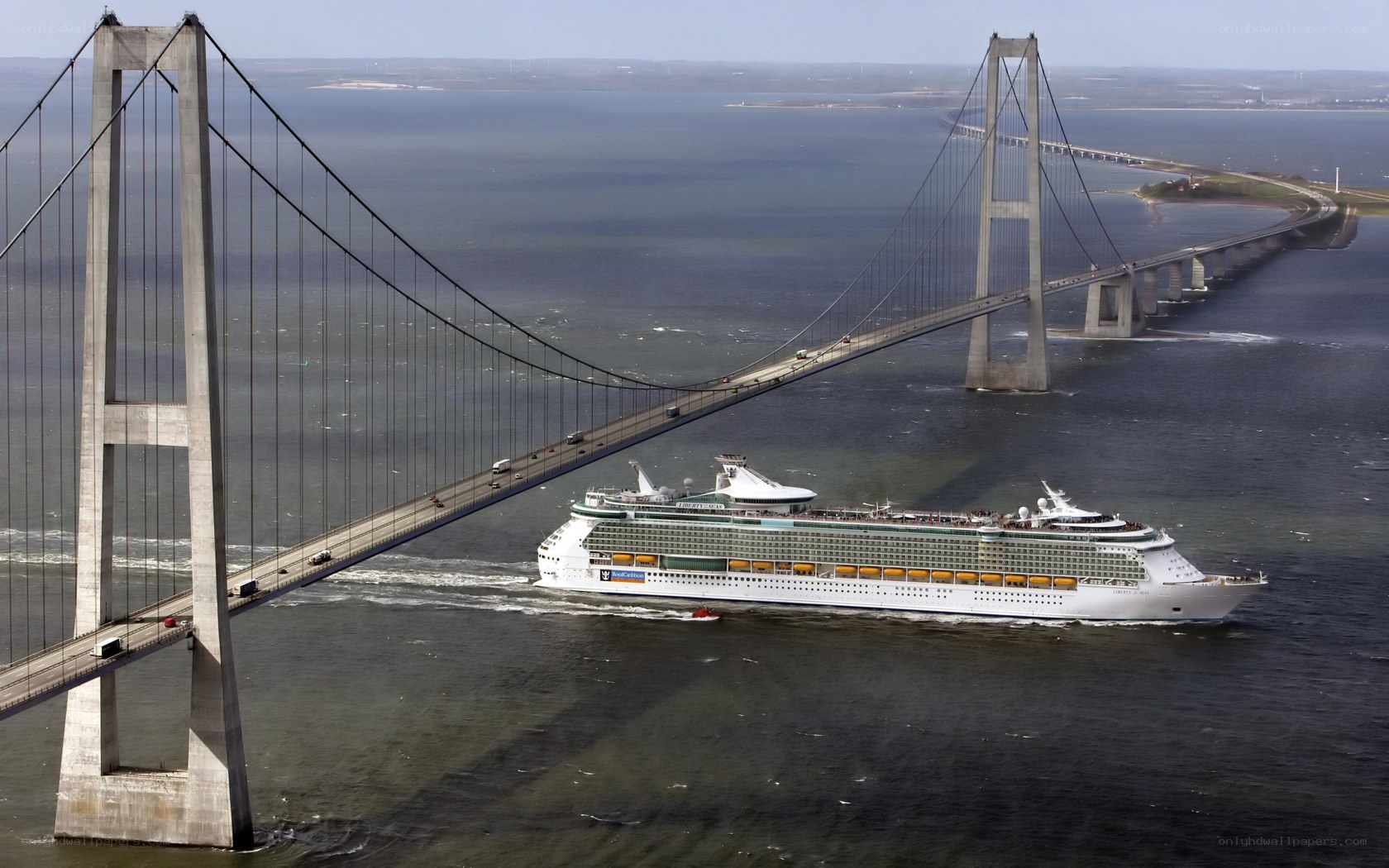 Cruise ship under a bridge