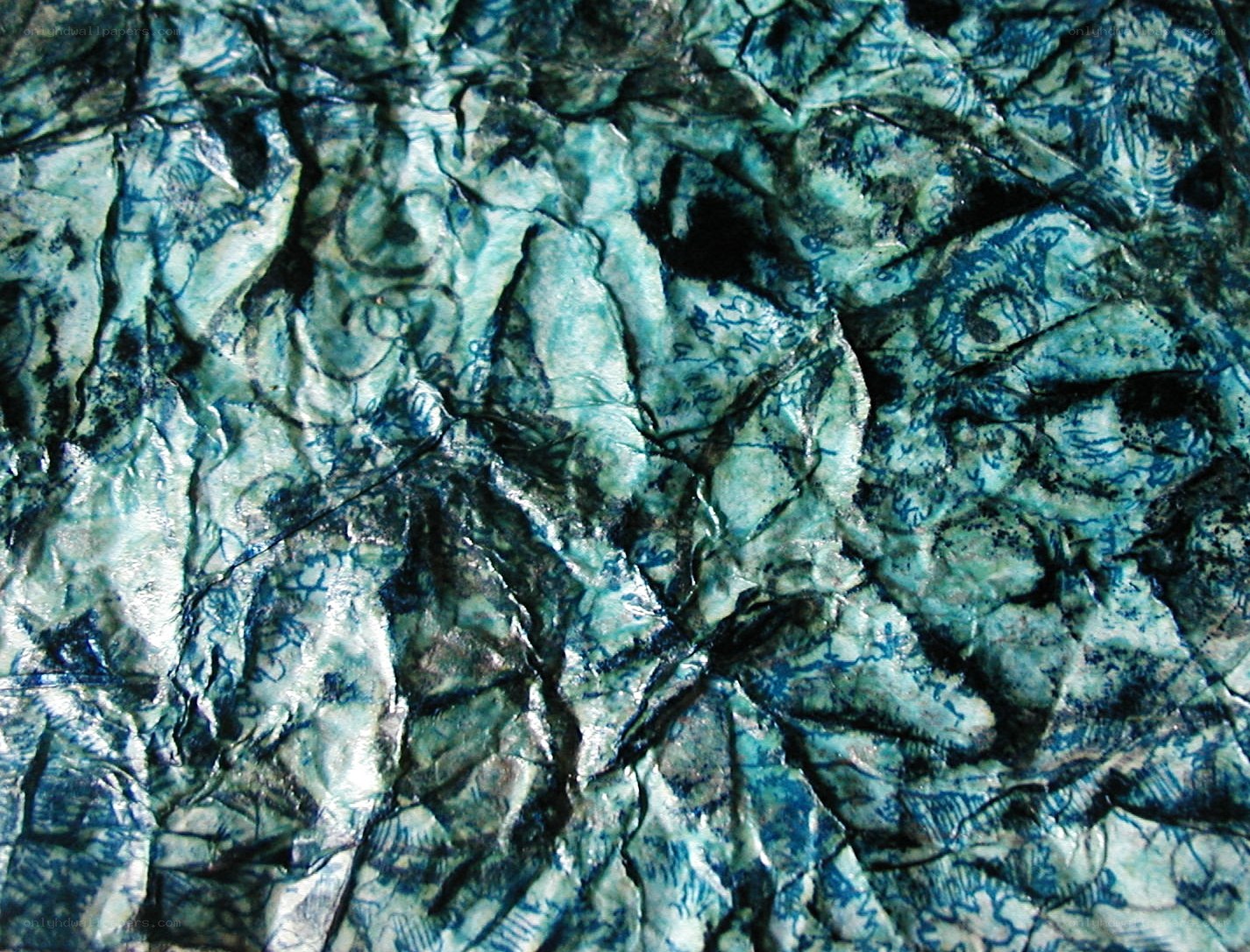 crumpled blue-green fabric texture