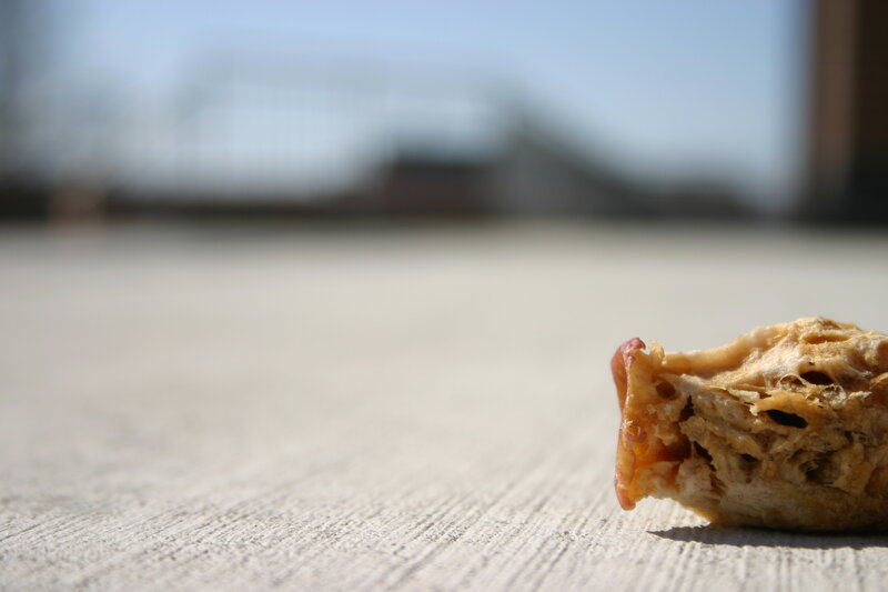 crumpled bread on pavement