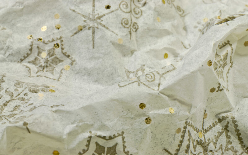 crumpled gift paper with gold patterns