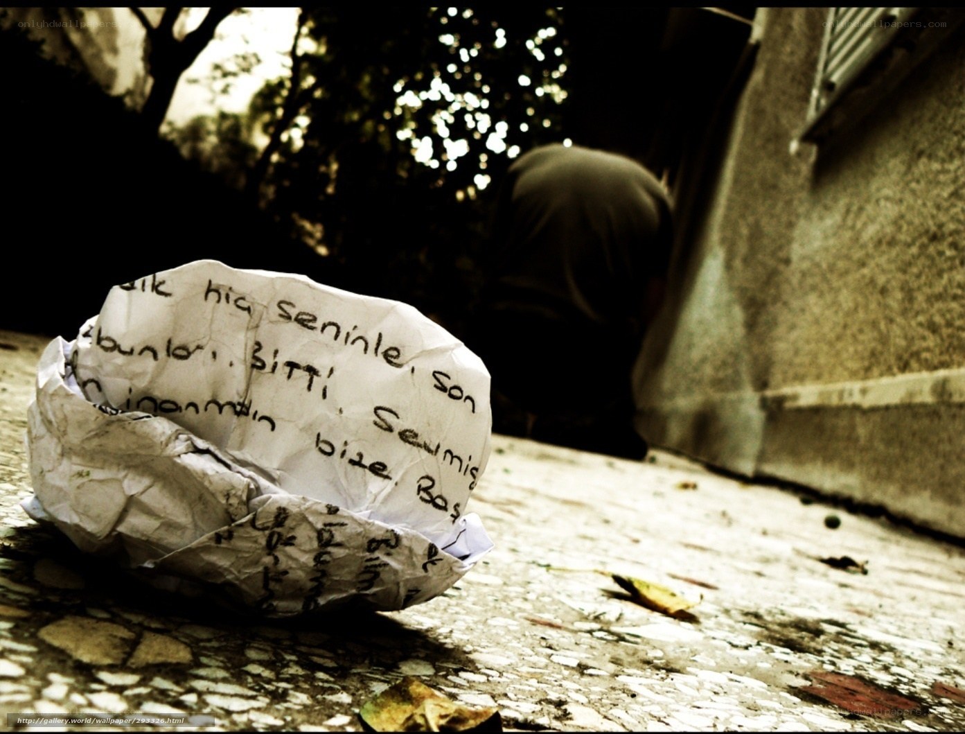 crumpled note on pavement