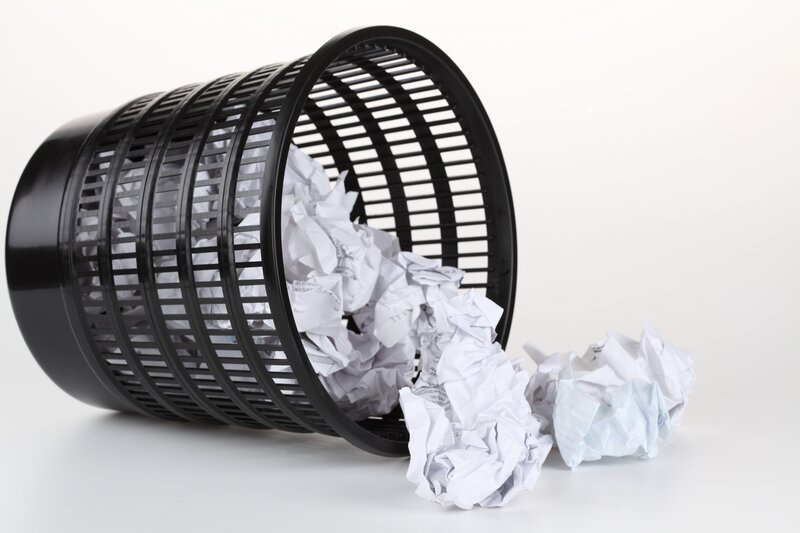 crumpled paper in trash can