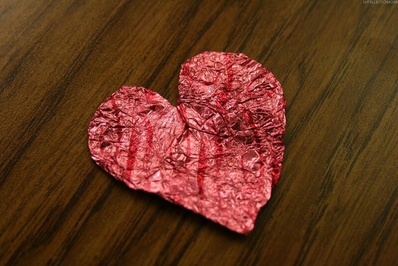crumpled red heart on wood