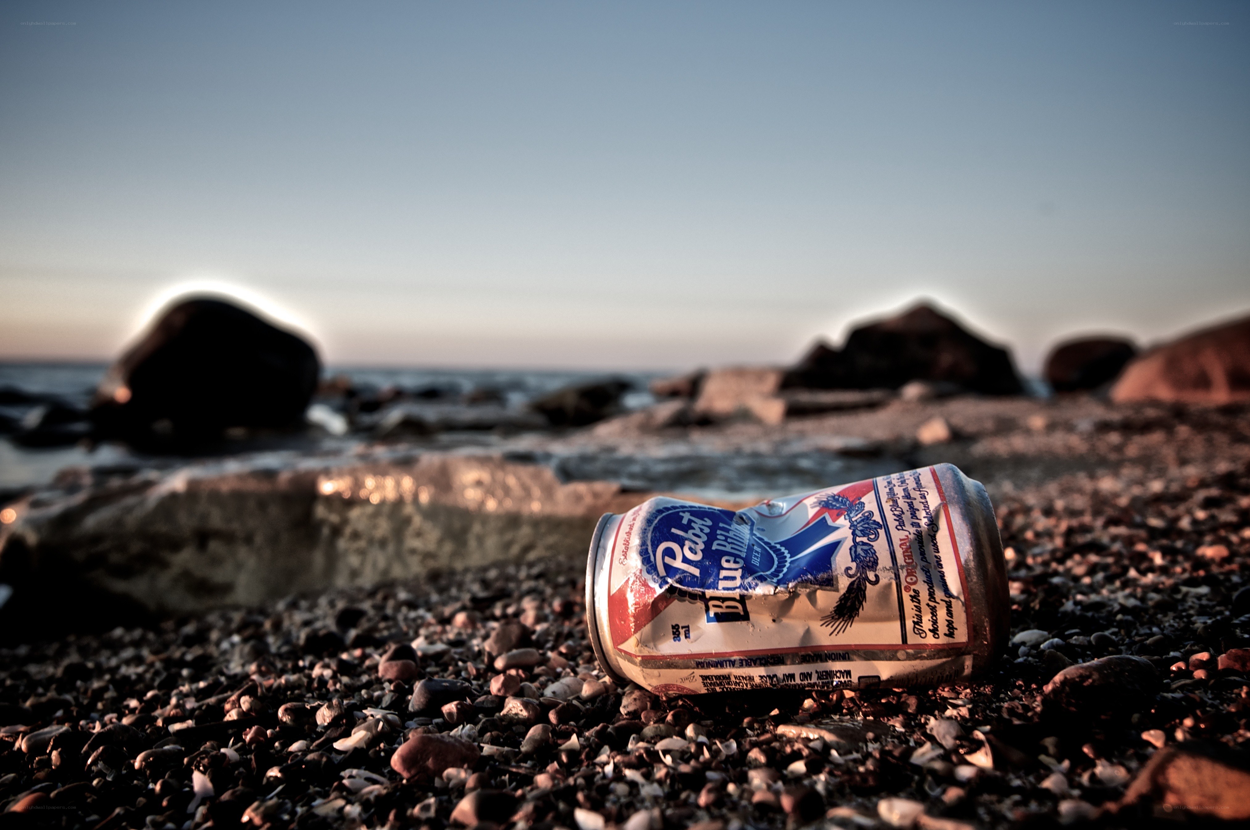 Crushed can on a pebble beach