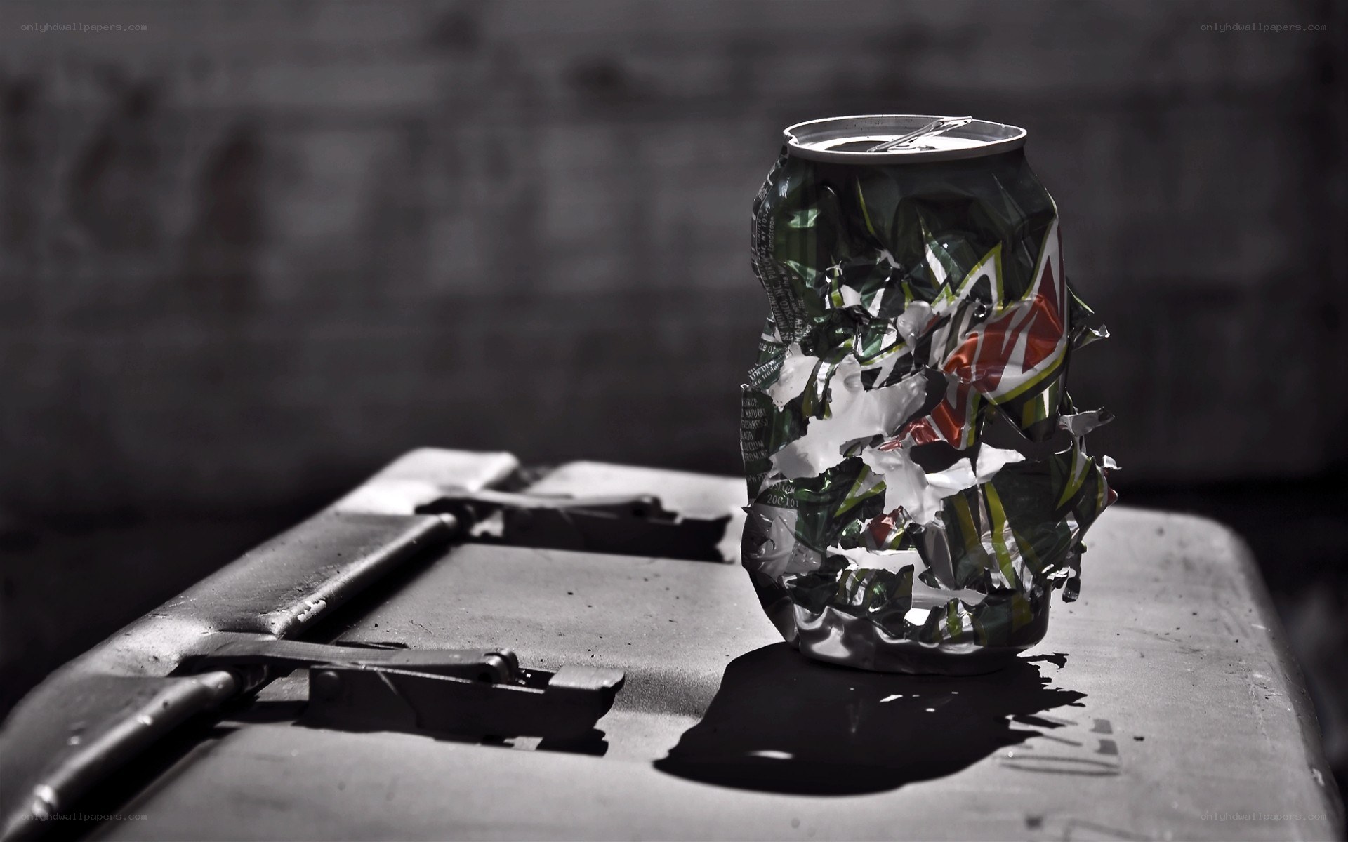 crushed soda can on metal surface