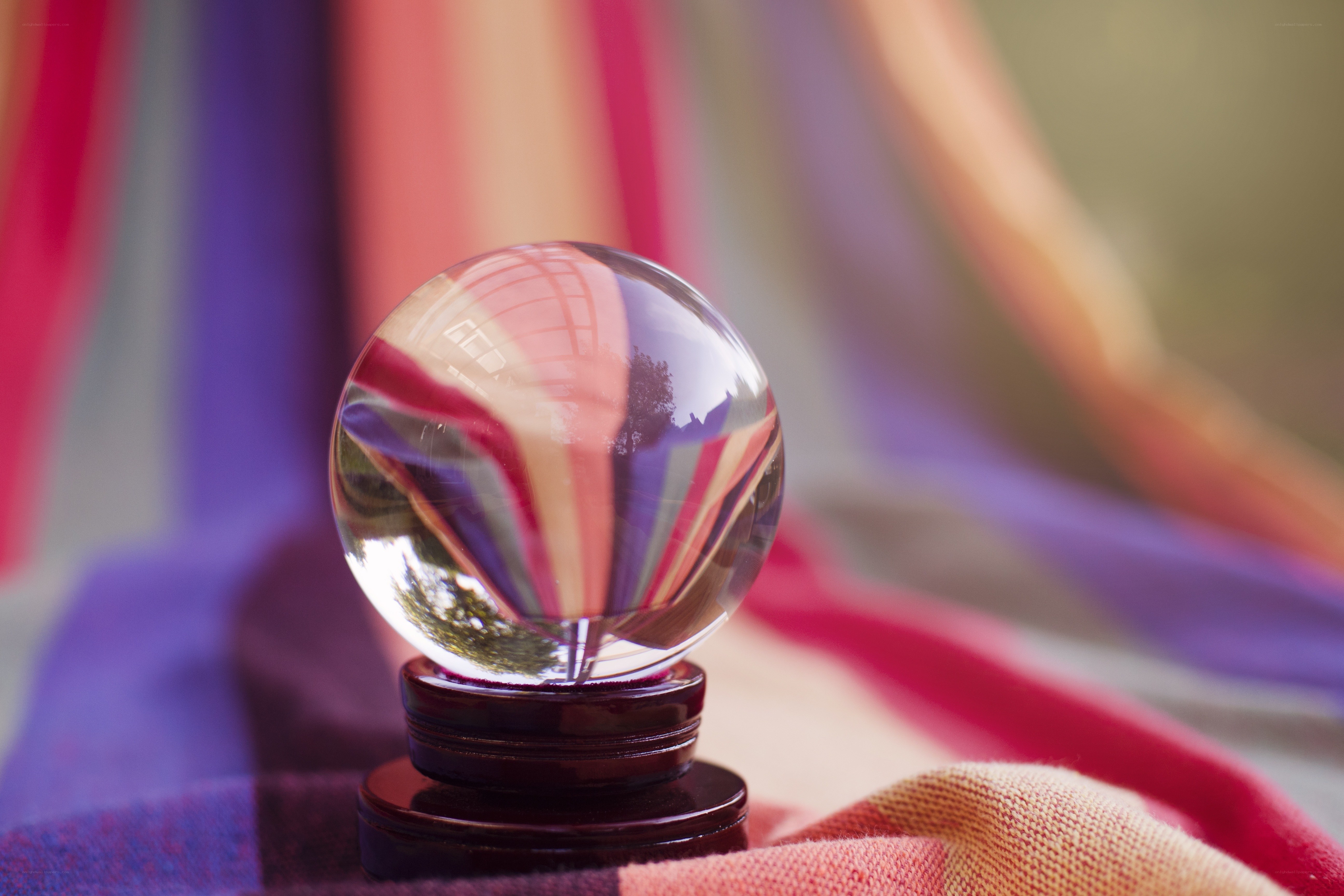 Crystal ball on colorful fabric