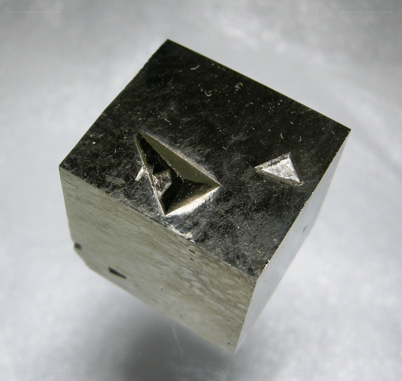 cubic metal specimen with indentations