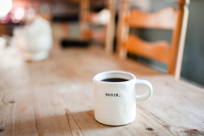 Cup with 'BEGIN' on table