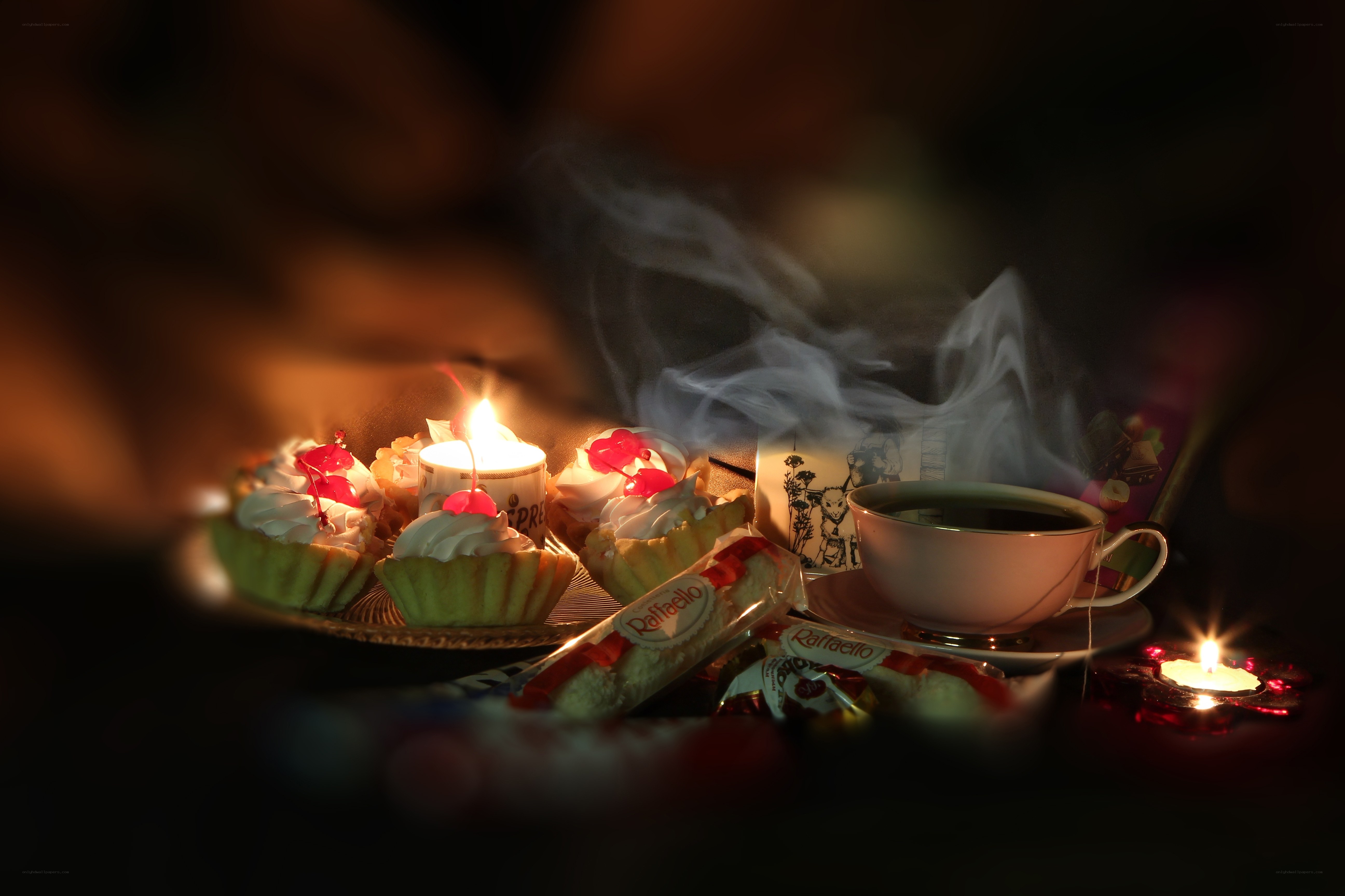Cupcakes and tea with candles
