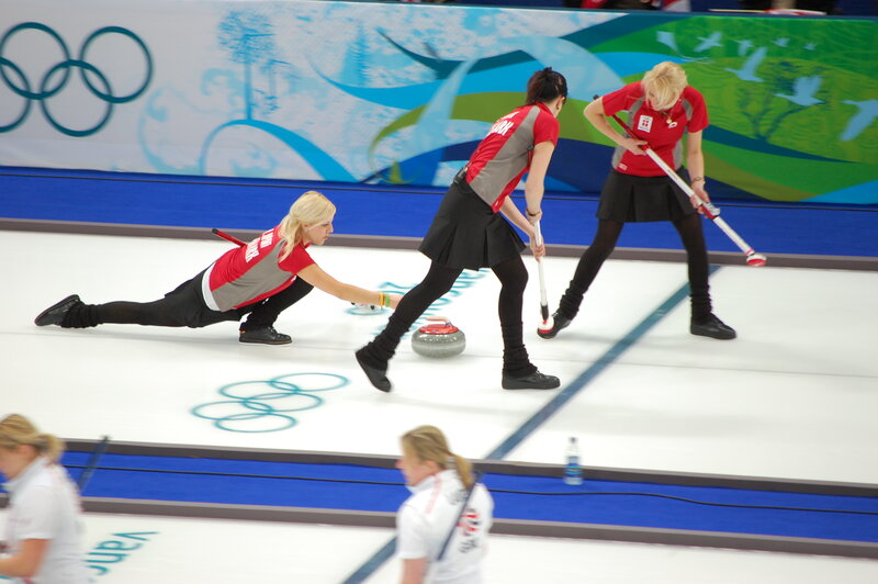 Curling athletes in action