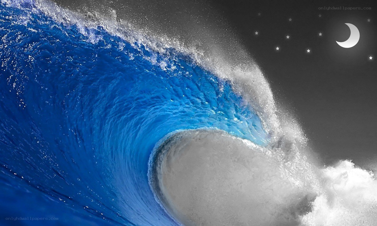 Curling ocean wave at night