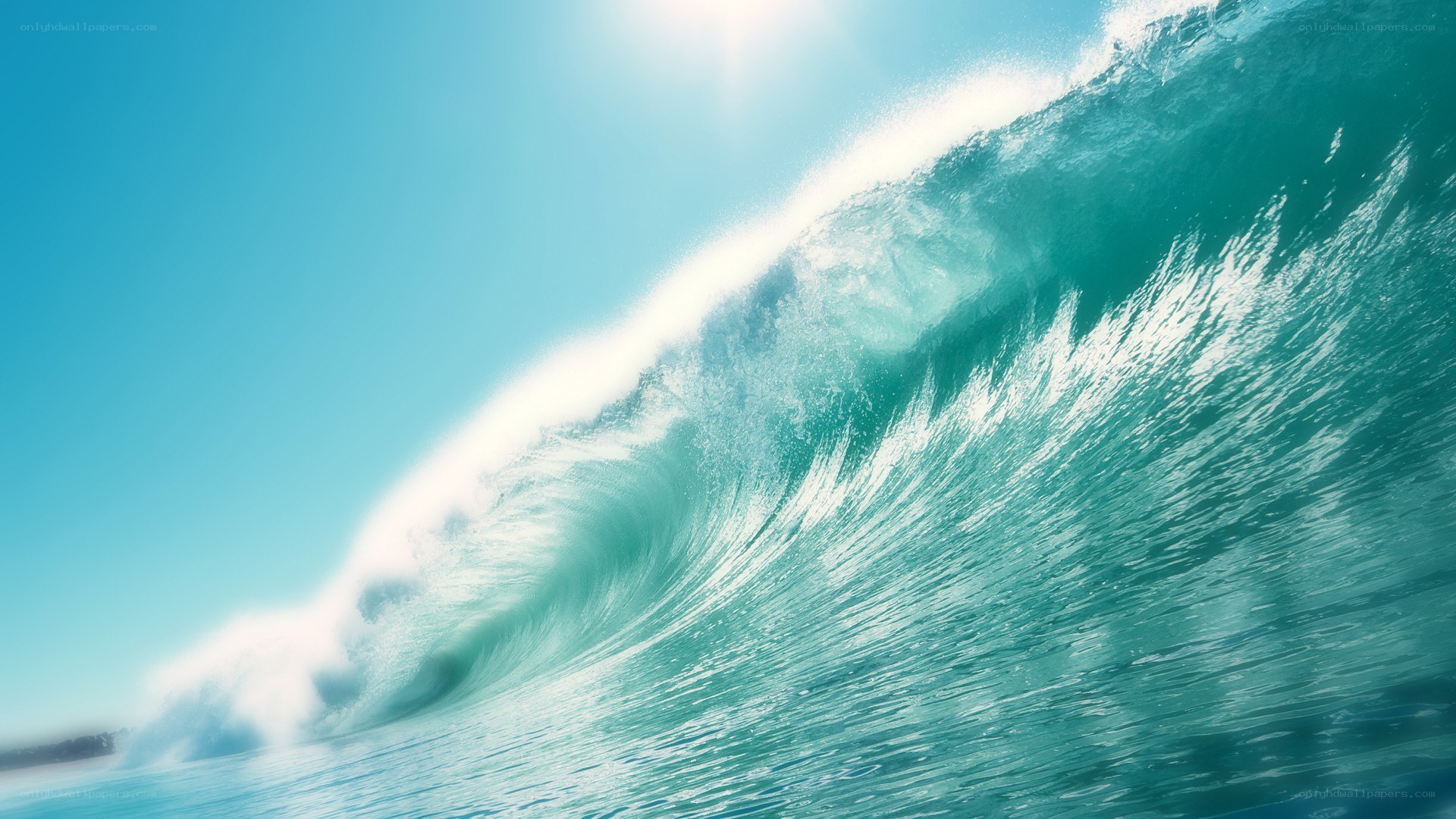 Curling ocean wave under blue sky