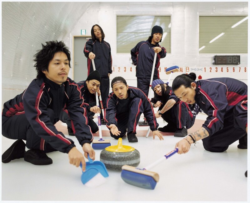Curling team posing on ice