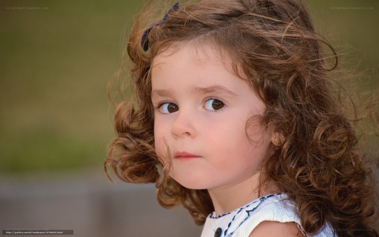 curly-haired girl looking away