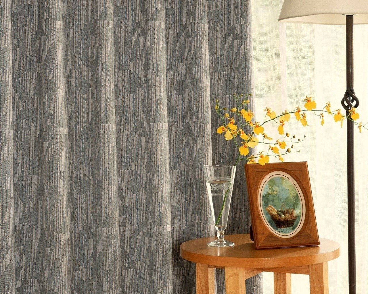 Curtains and flowers on table