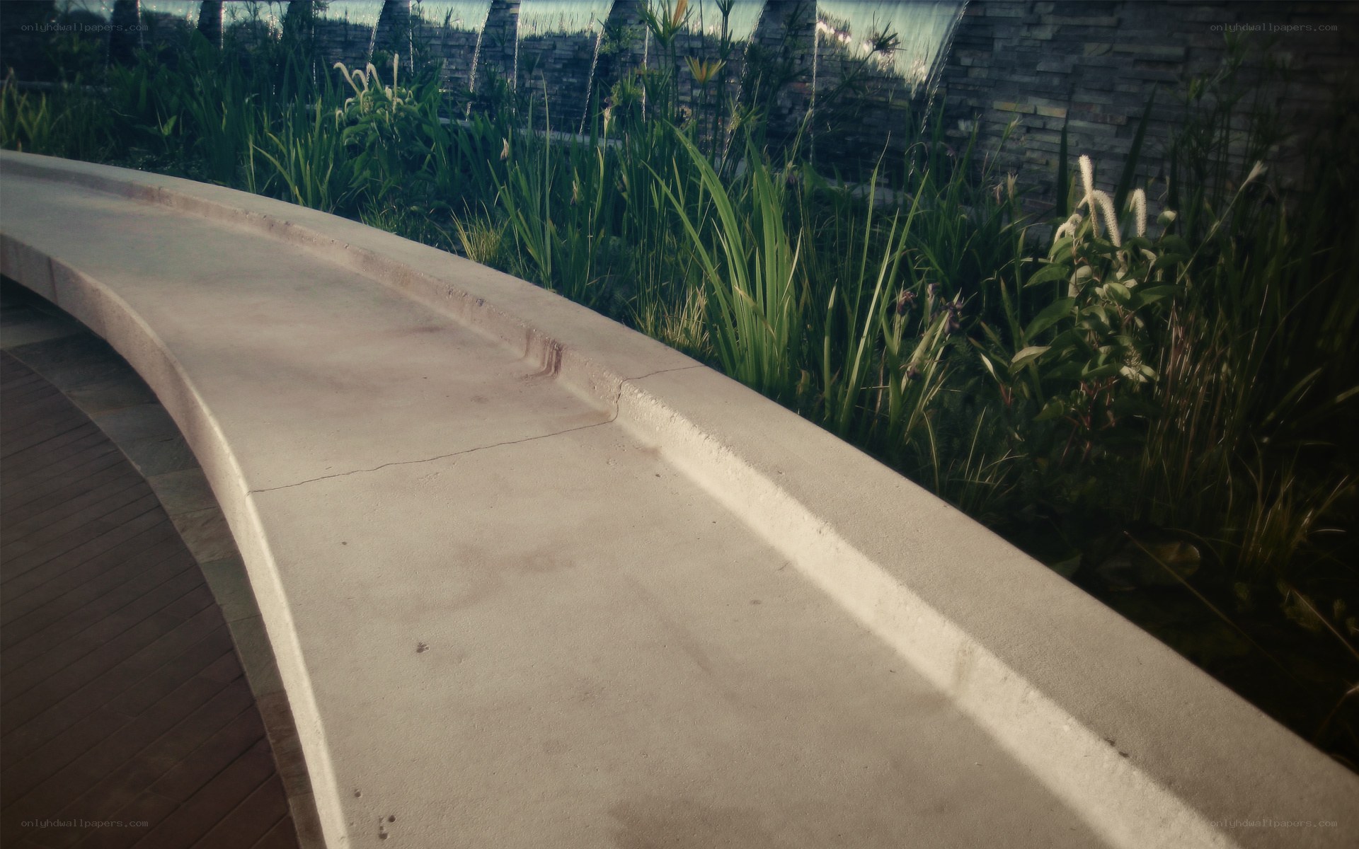 curved concrete bench in garden