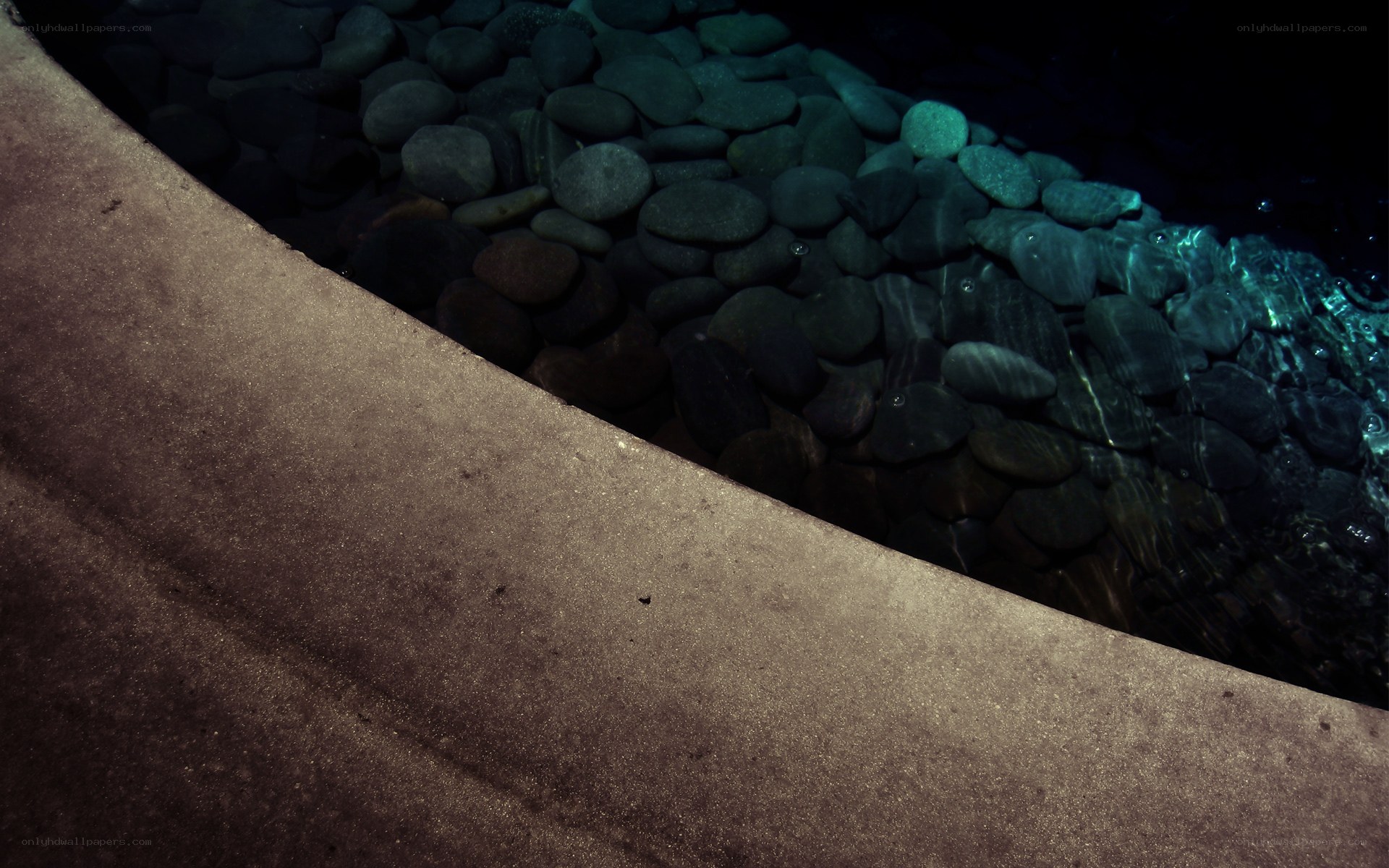 curved concrete edge with pebbles