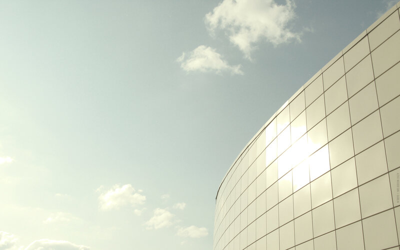 curved glass building under sky