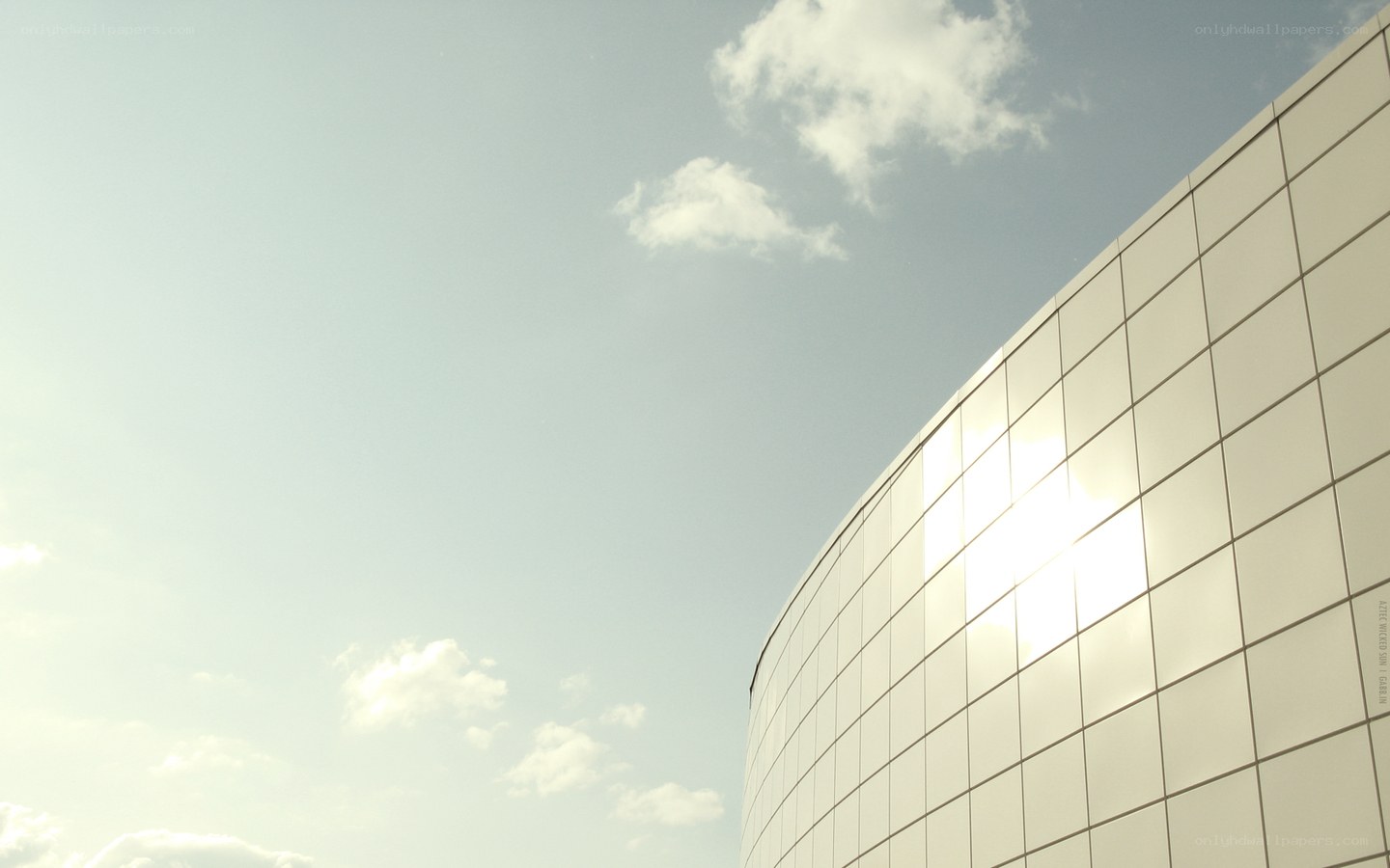 curved glass building under sky
