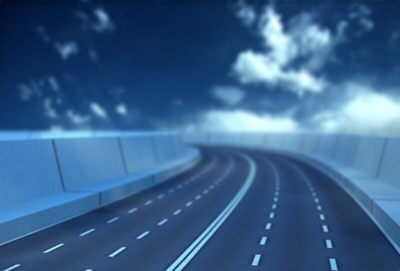 curved highway under cloudy sky