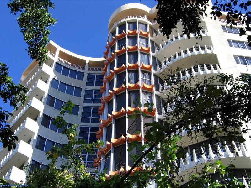 curved hotel building with orange accents