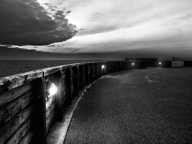 curved pier at dusk
