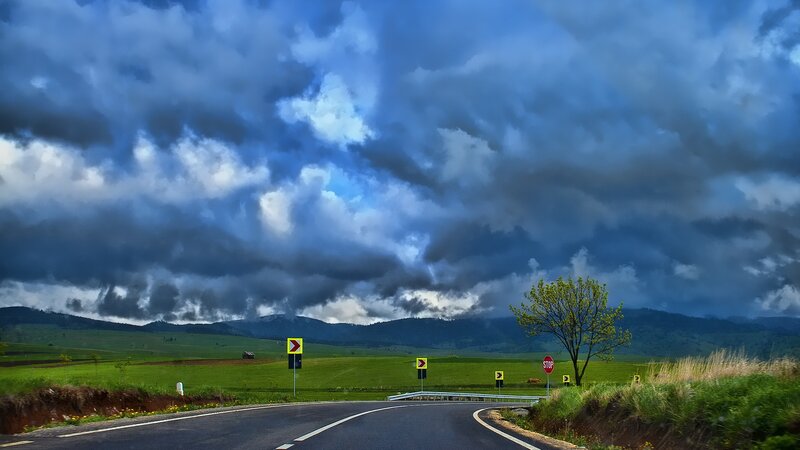 Curved Road under Stormy Sky