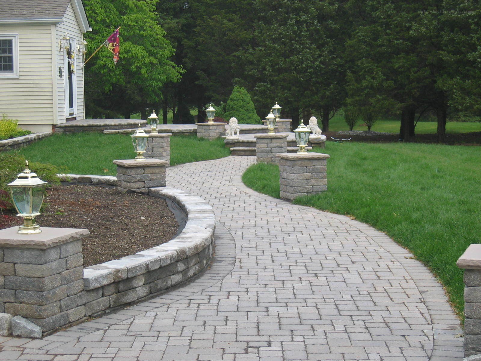 curved stone pathway with lanterns