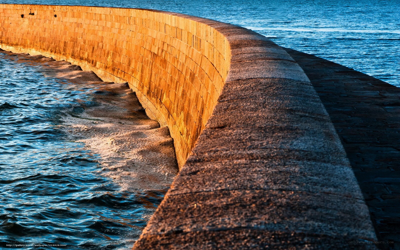curved stone pier at sunset