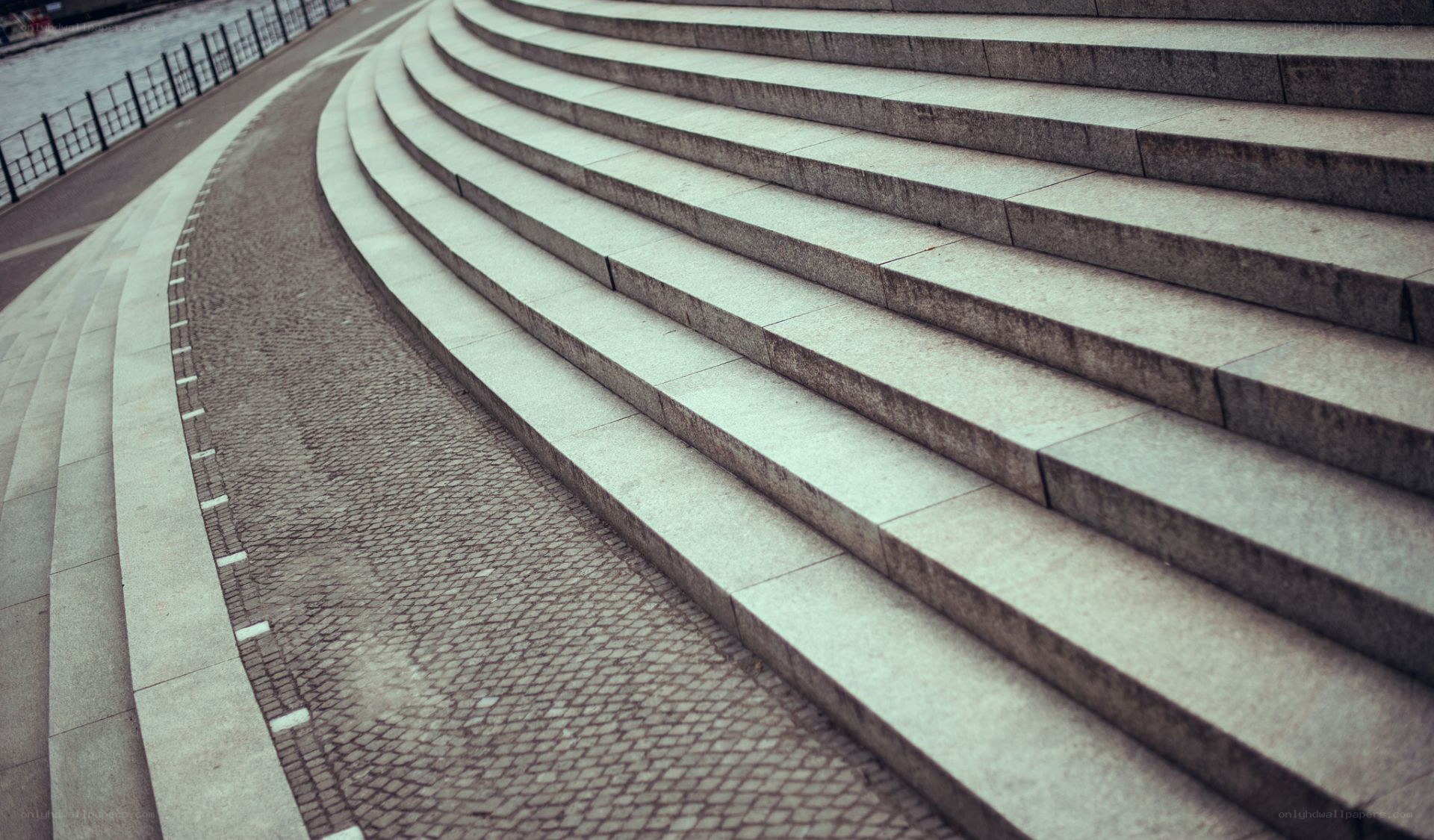 curved stone steps by water