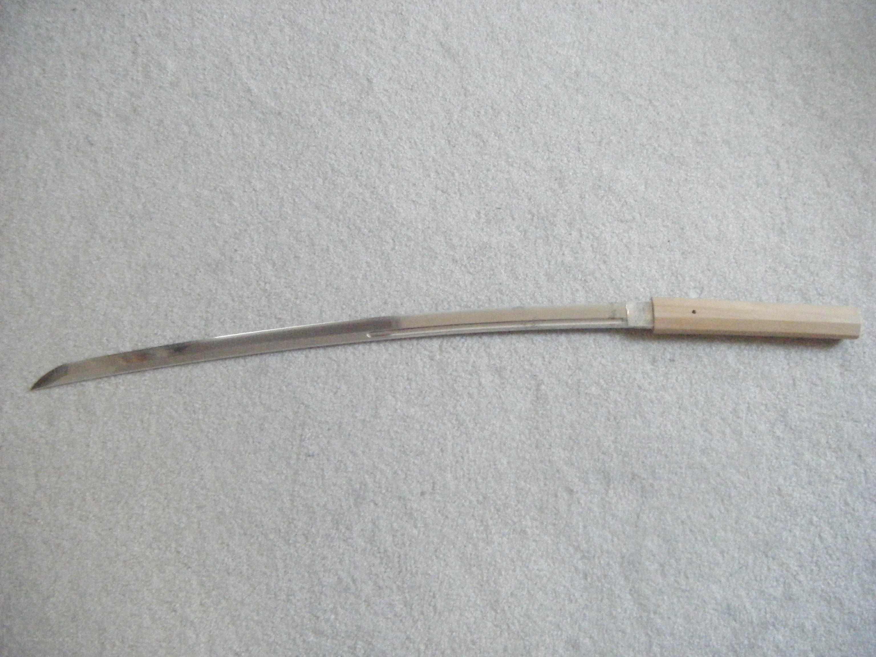 curved sword on carpet