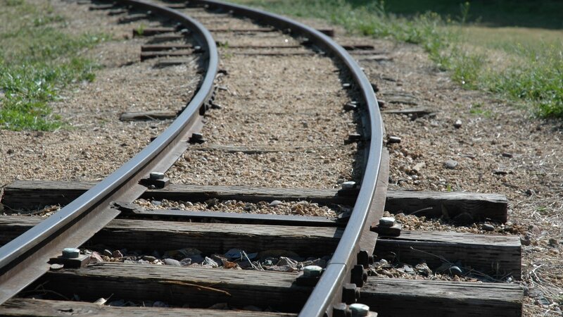 curved train track in sunlight