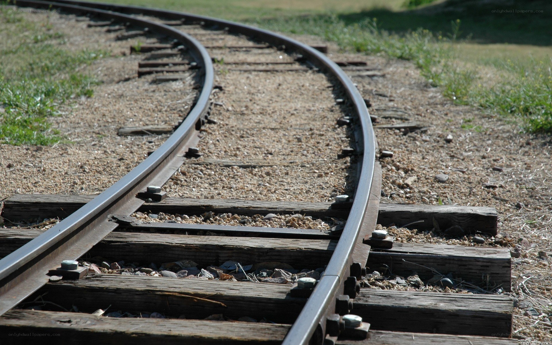 curved train tracks in sunlight