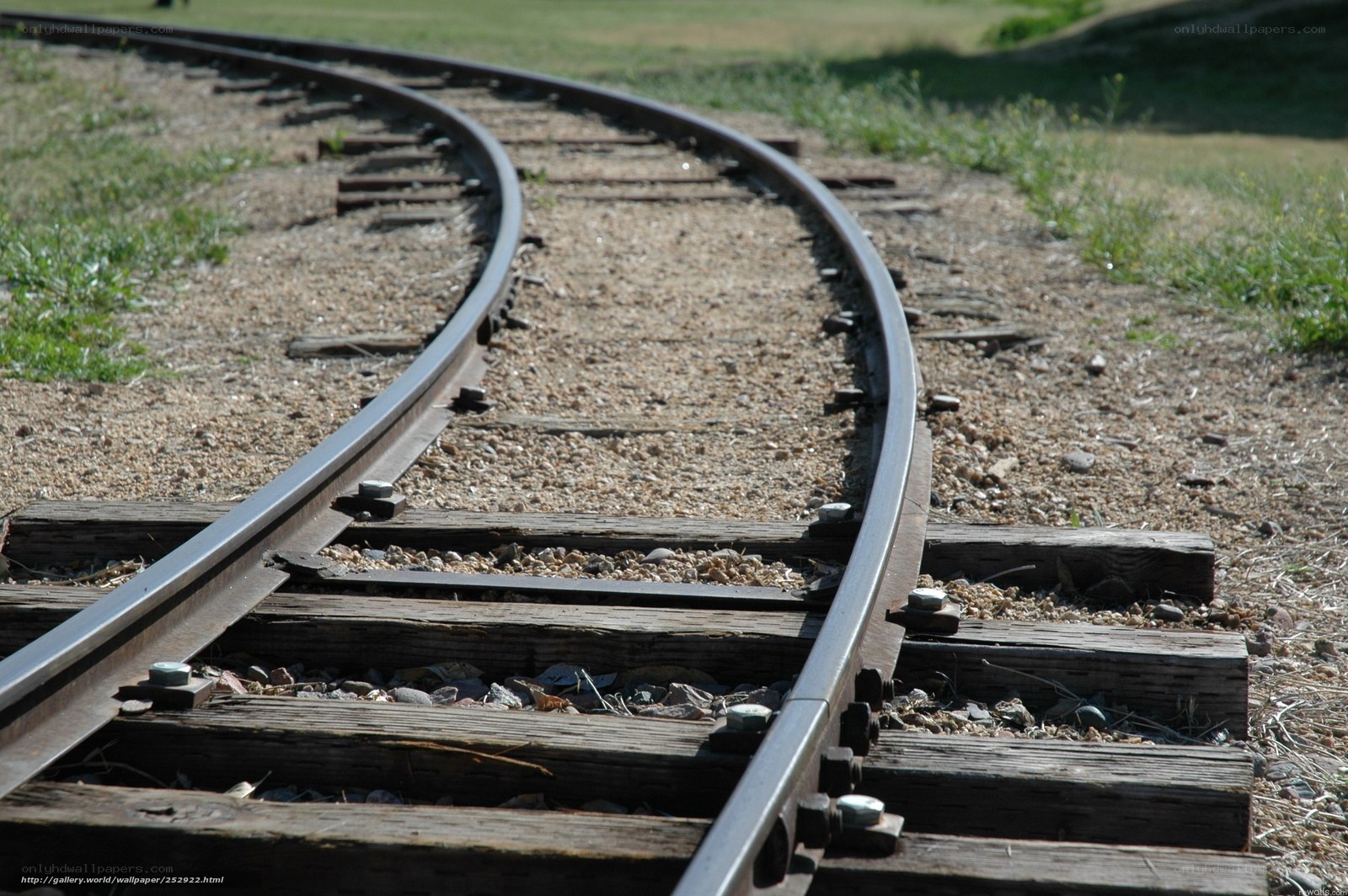 curved train tracks in sunlight