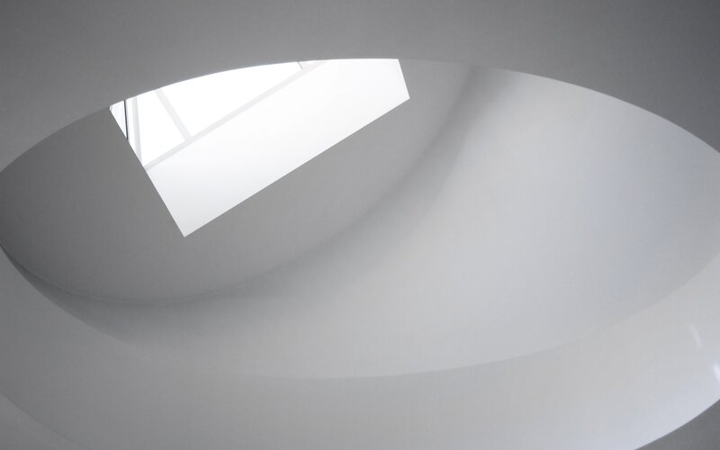 curved white ceiling with skylight
