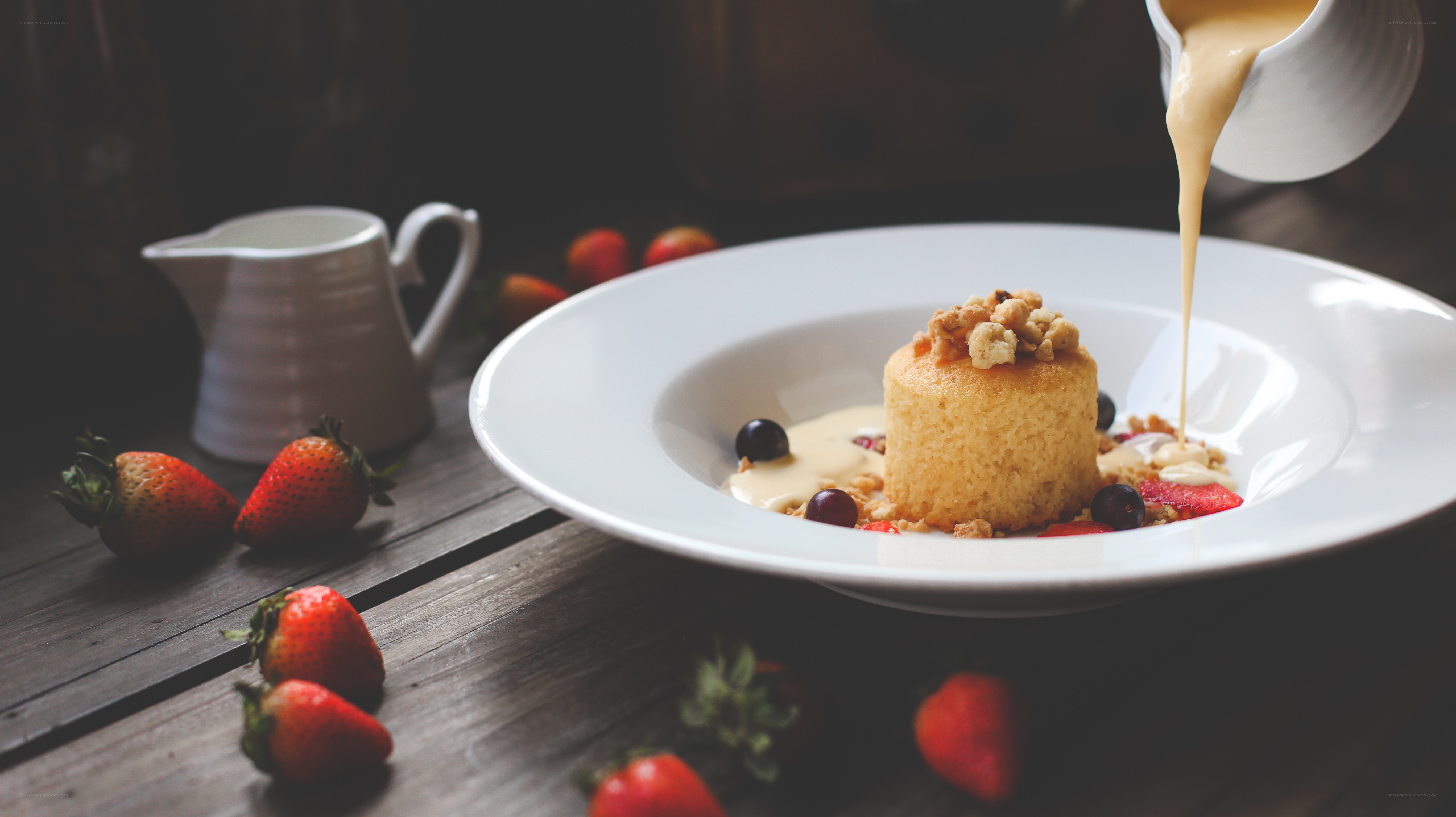 custard being poured over dessert
