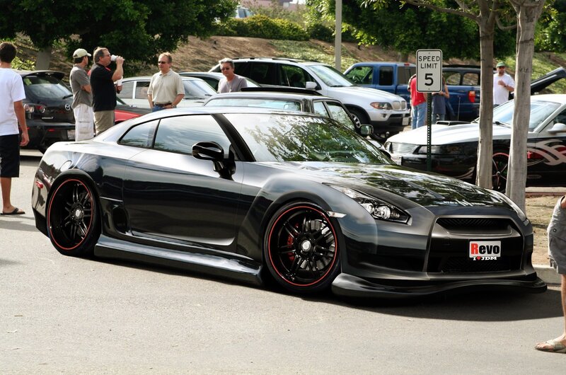 Custom black sports car at a show